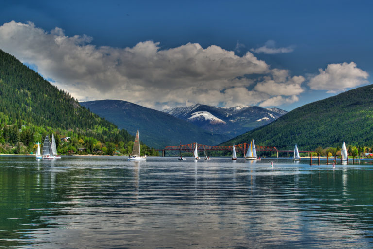 A group of sailboats in front of the Big Orange Bridge in Nelson, BC.